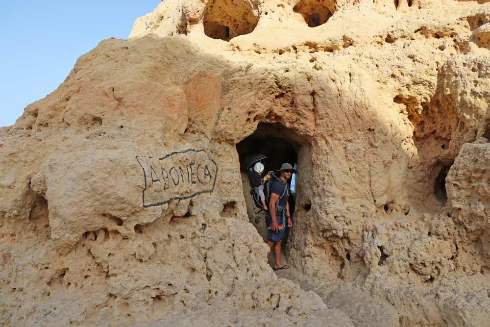 A narrow entrance to A Boneca Cave in the Algarve
